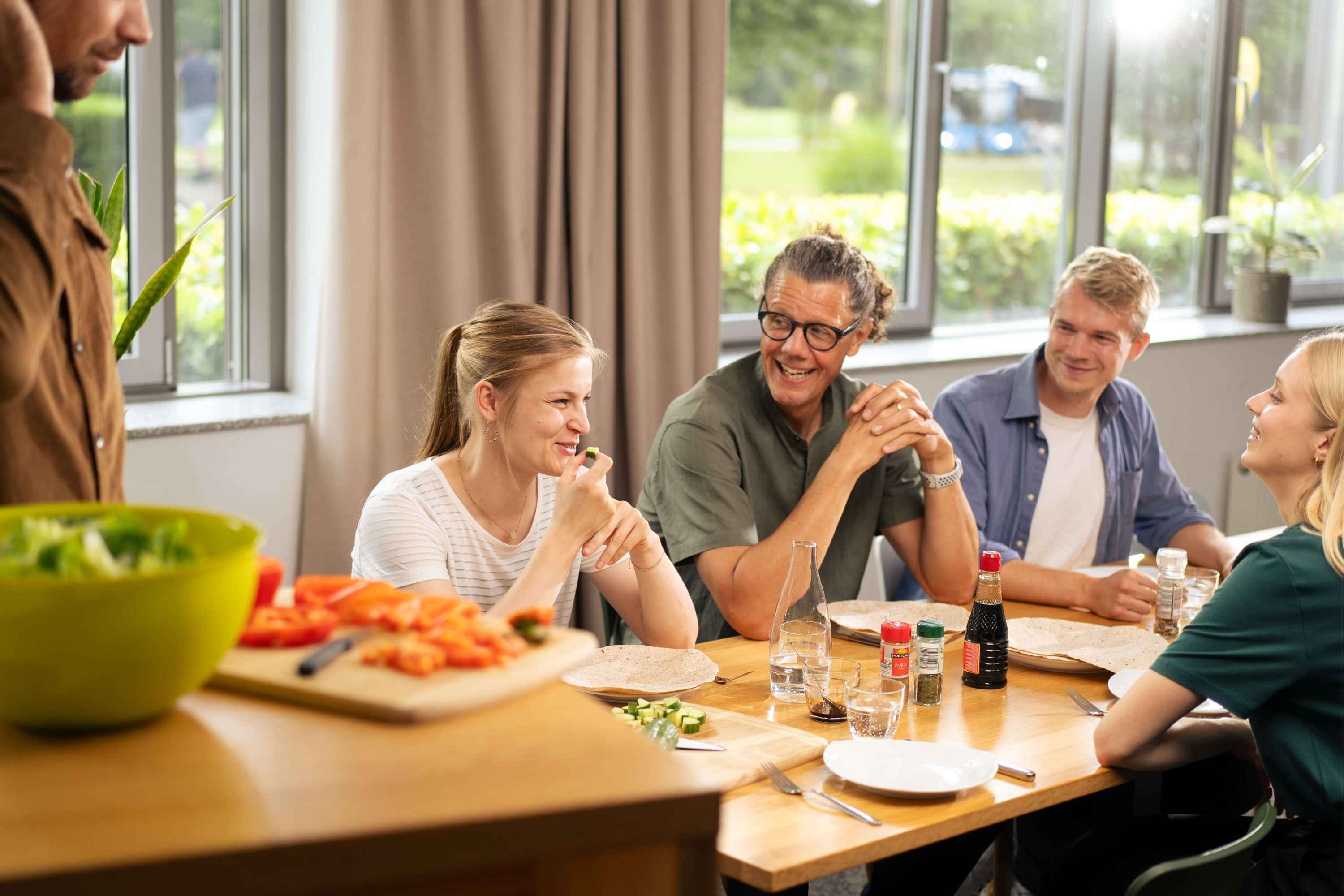 Christian Schulze-Dieckhoff und andere Mitarbeiter:innen der viadee beim gemeinsamen Mittagessen in den Räumen der viadee.
